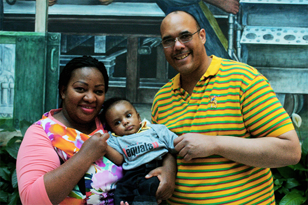 Aaron Anderson with Claire Gasamagera and their son Calvin.