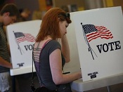 woman at voting booth