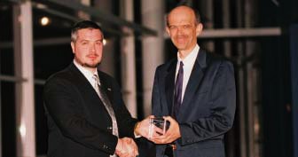 IAPAC President/CEO Jos&eacute; M. Zuniga presents F. James Muller with his 2002 Hero in Medicine award.