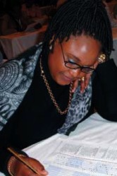 Nokukhanya Mdlalose, a South African family practitioner, writes the GALEN Certification Examination during its June 9, 2005, administration in Durban, South Africa. (Photo: Jaz Hughes)