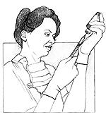 Health care provider wearing gloves, drawing medicine into a syringe.