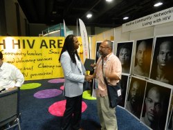 CDC's Rashad Burgess and visitor at NAPWA's Global Village Booth.