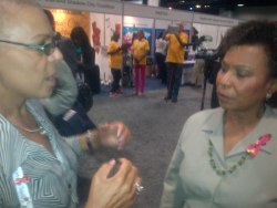 NAPWA's SABER program manager Mimi Miner talks with Congresswoman Barbara Lee.