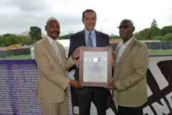 District of Columbia Mayor Vincent Gray receiving Positive Leadership Award -- NAPWA's Frank Oldham (left) and Executive Vice President Stephen Bailous (right).