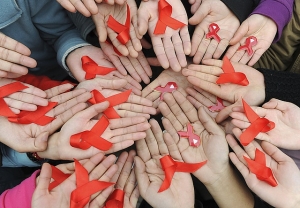 University students hold red ribbons during an HIV/AIDS awareness rally on World AIDS day in Chengdu, Sichuan province on December 1, 2009. &copy; 2009 Reuters.