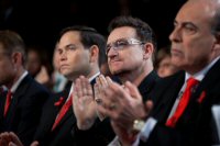 Musician Bono, center,  listens as President Barack Obama delivers remarks at a World AIDS Day event at George Washington University  in Washington, D.C.,  Dec. 1, 2011. (Official White House Photo by Pete Souza)