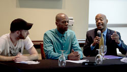 At the Atlanta Principles press conference, ACT UP New York's James Krellenstein and Adolph Arromand of National AIDS and Education Services for Minorities (NAESM) consider the testimony of longtime Atlanta activist living with HIV, Craig Washington of AID Atlanta. (Credit: Cathy Metzger)